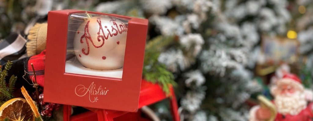 A personalised bauble inside a burgundy gift box 