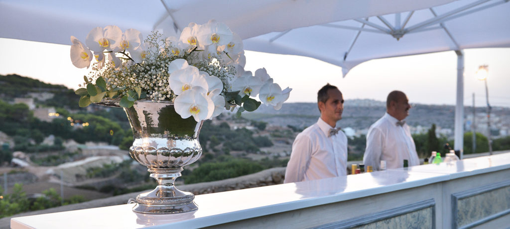 A bar with a floral arrangement on top