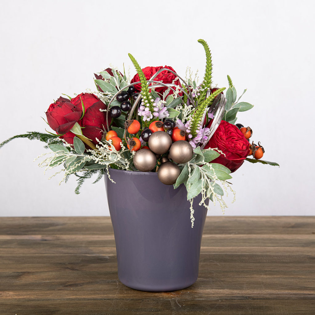 Mixed red florals in a nice blue vase part of the Nordic Bloom Collection.