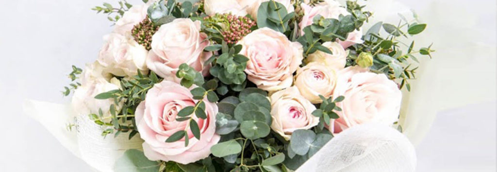 A bouquet with plush pink roses and peonies.