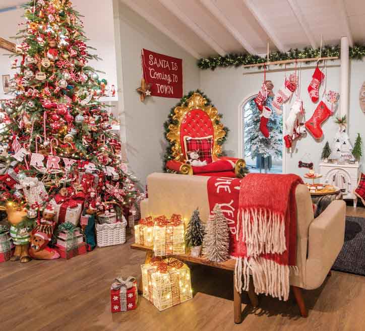 A living room decorated with many different red Christmas decor.